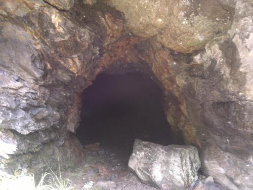 a dark cave in a large rock at Cabana Dara in Cumpăna