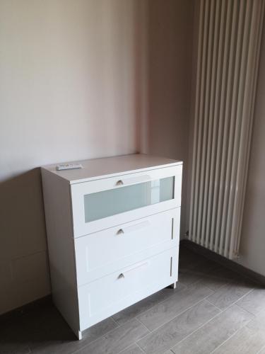 a white dresser in a room next to a radiator at Slowliday in Viverone