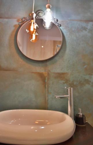 a bathroom with a sink and a mirror on the wall at Vila Vidalis in Cluj-Napoca