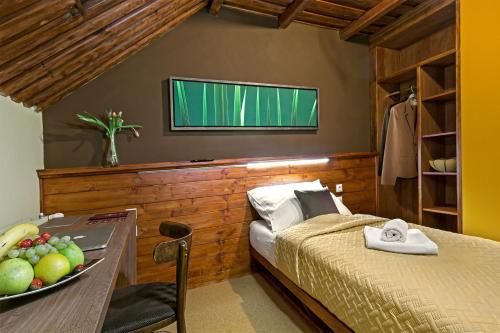 a bedroom with a bed and a table with a bowl of fruit at Penzión Restart House - Spiššská Sobota in Poprad