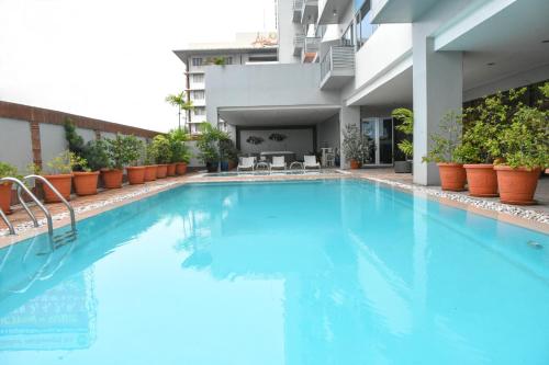 a swimming pool with blue water in a building at Alicia Apartelle in Cebu City