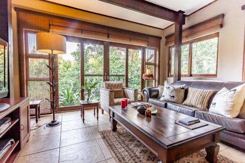 a living room with a couch and a table at One On Hely in Mtunzini