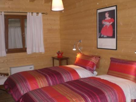 a bedroom with two beds and a picture of a woman at Pera Rionda in Caprie