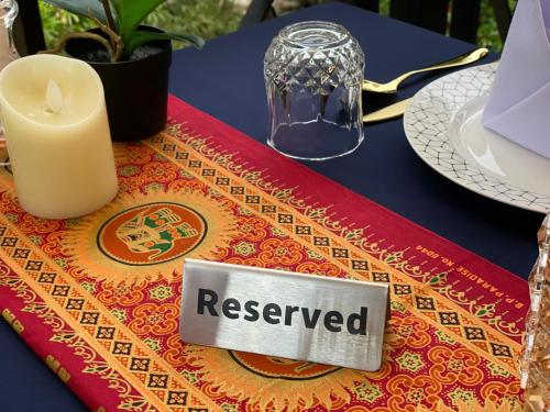 a reserved sign on a table with a candle at The Scene Cliff View Villas in Ao Nang Beach
