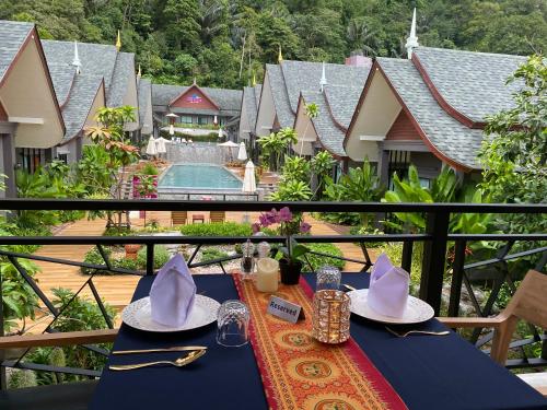 a table with hats on top of a balcony at The Scene Cliff View Villas in Ao Nang Beach
