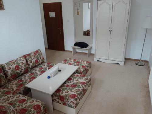 a living room with a couch and a coffee table at Hotel Condor in Oraviţa
