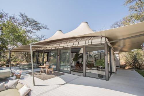 a pavilion with a roof on a patio at Saseka Tented Camp in Hoedspruit