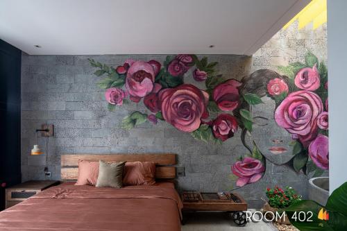 a bedroom with a wall with a mural of roses at Deja Vu House Ha Long in Ha Long