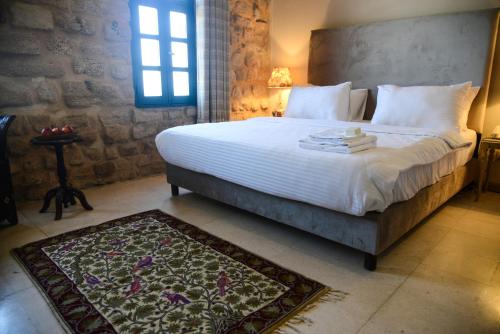 Ένα ή περισσότερα κρεβάτια σε δωμάτιο στο Al Qualaa Boutique Hotel