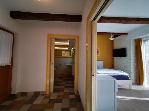 a room with a bedroom with a bed and a bathroom at Penzion Okamžik Stanovice in Nová Cerekev