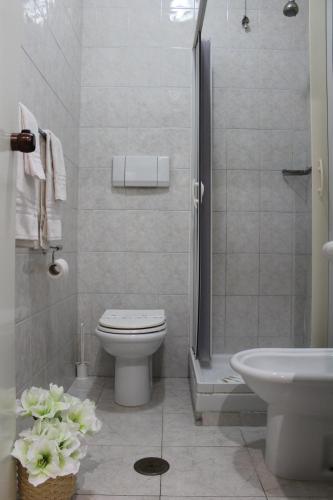 a bathroom with a toilet and a shower and a sink at Hotel Cristallo Relais, Sure Hotel Collection By Best Western in Tivoli