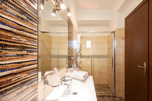 a bathroom with a sink and a mirror at Four Seasons Villas in Skiathos Town
