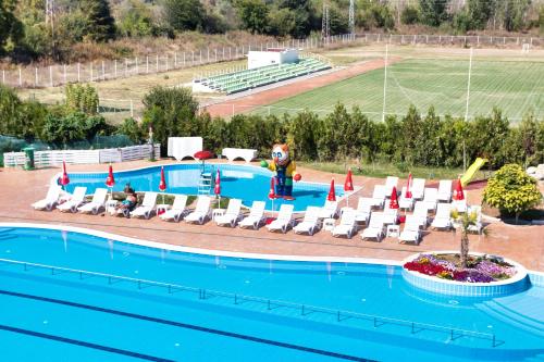 a pool at a resort with chairs and a slide at Balneo and SPA Complex MINERAL YAGODA in Yagoda