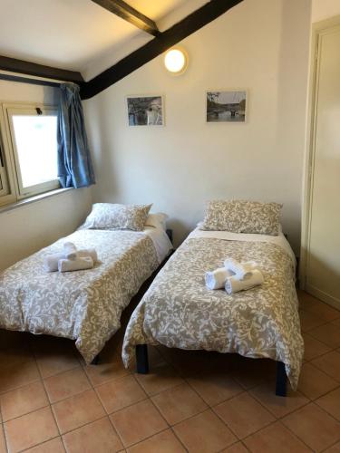 a bedroom with two beds with towels on them at Domus Santa Caterina in Rome
