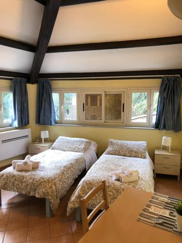 a bedroom with two beds and a table at Domus Santa Caterina in Rome