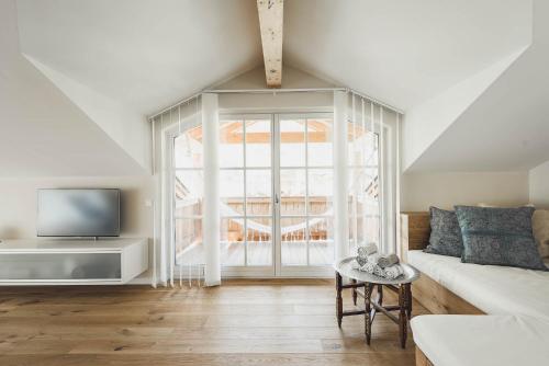 a living room with a white couch and a window at Chalet Stolz in Grossarl