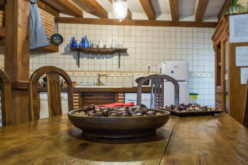 miskę jedzenia na drewnianym stole w kuchni w obiekcie Casa Rural El Capricho w mieście Otero de Herreros