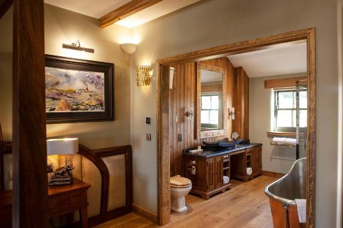 a bathroom with a tub and a toilet and a sink at Black Horse Beamish in Stanley