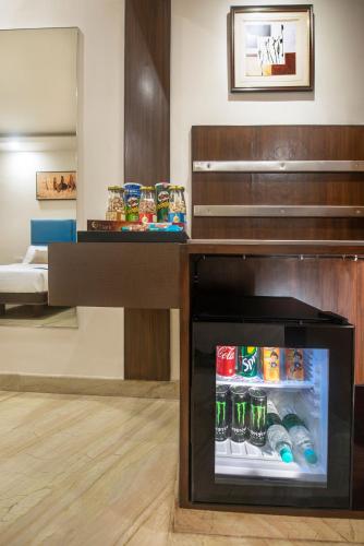 a refrigerator with drinks in it in a room at The Fern Residency - Yeshwanthpur in Bengaluru