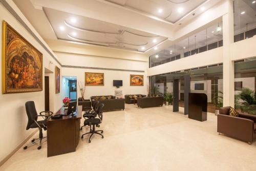 a lobby with couches and chairs in a building at The Fern Residency - Yeshwanthpur in Bengaluru