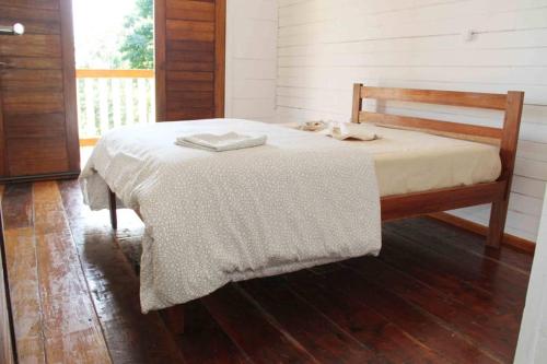 a bedroom with a bed with two towels on it at BEMA FARM in São José