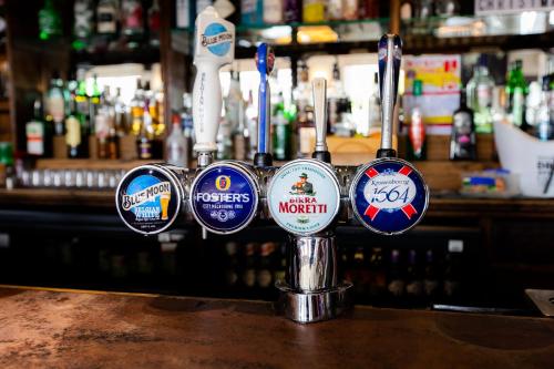a bar with a bunch of stickers on a counter at Blue Boar Inn in Norwich