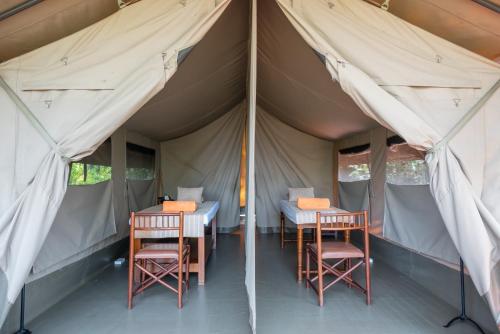 a tent with two tables and chairs in it at Sarova Lion Hill Game Lodge in Nakuru