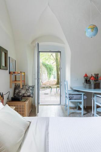 a bedroom with a bed and a table and chairs at Lacasadiscorta in Almè