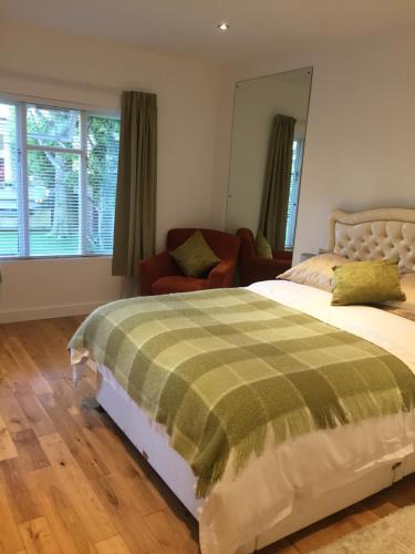 a bedroom with a bed and a living room at The Coach House in Cardiff