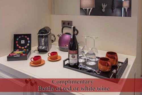 a kitchen counter with a bottle of red or white wine at Hotel Miniature - Ottoman Mansion in Istanbul