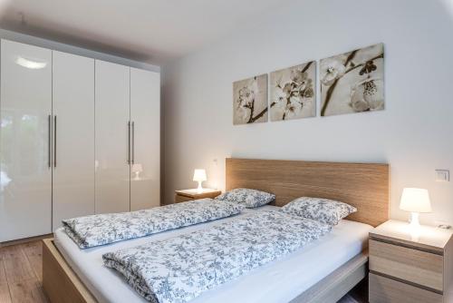 a bedroom with a large bed with two lamps at Villa Natasha - charming Istrian villa with private heated pool in Ružići