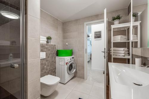 a bathroom with a washing machine and a sink at Villa Natasha - charming Istrian villa with private heated pool in Ružići
