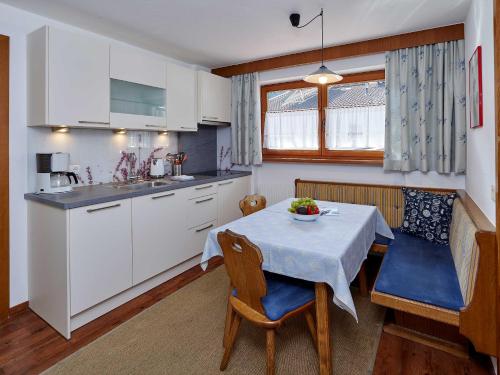 a kitchen and dining room with a table and chairs at Kristiania in Sölden