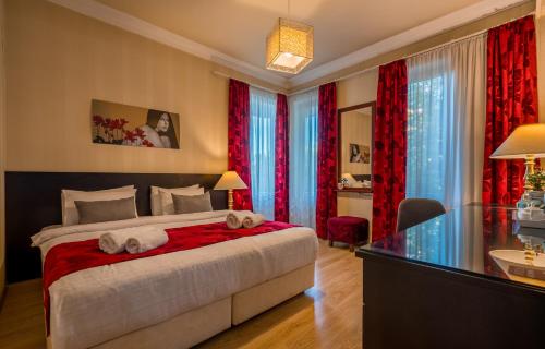 a bedroom with a bed with two towels at Iliani Hotel in Tbilisi City