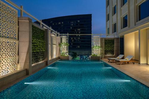 a swimming pool on the side of a building at Lemon Tree Premier, New Town, Kolkata in Kolkata