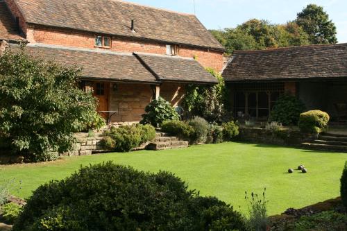 a large yard in front of a house at Haywains Self-Catering at Boningale Manor in Wolverhampton