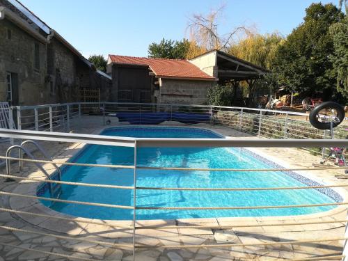 a swimming pool with a metal fence around it at La Grange du Layon in Saint-Georges-sur-Layon