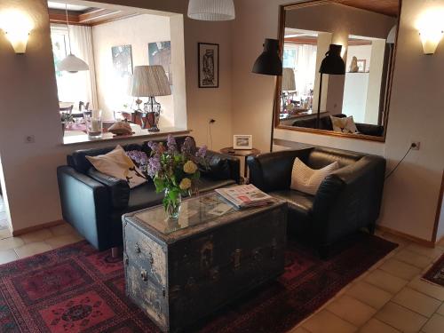 a living room with a couch and a table at Hotel KAMPS in Sinsheim