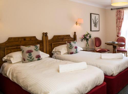 a hotel room with two beds in a room at Flackley Ash Country House Hotel in Rye