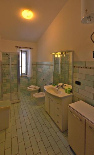 a bathroom with a sink and a toilet and a sink at Villa Arancio in Cala Liberotto