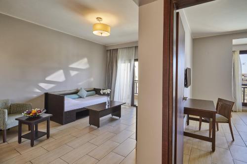 a living room with a couch and a table at Steigenberger Aqua Magic, All inclusive in Hurghada