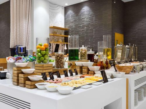 a buffet of food on a table in a room at Mercure Sohar in Sohar