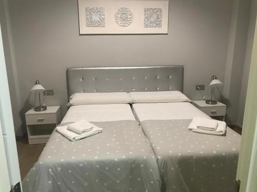 a bedroom with a bed with two towels on it at Deluxe Apartment in La Giralda in Seville