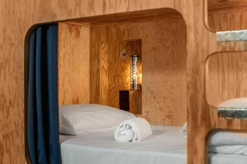 a bed in a room with a lamp on it at Eklo Clermont Ferrand Centre Gare in Clermont-Ferrand