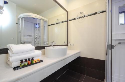 a bathroom with a sink and a mirror at Aeolis Boutique Hotel in Naxos Chora