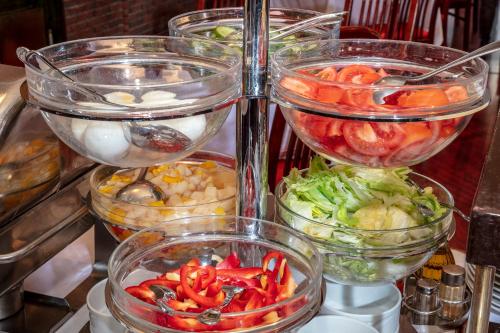 four clear bowls filled with different types of vegetables at Hotel Charles in Budapest