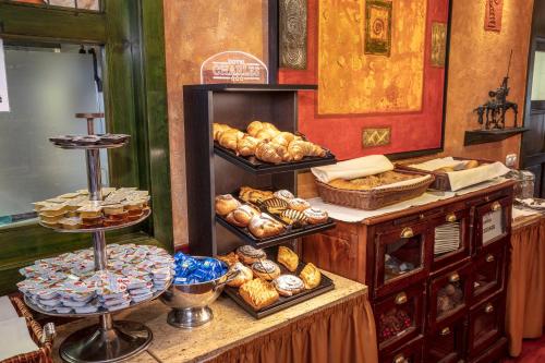 a bakery with bread and pastries on a counter at Hotel Charles in Budapest