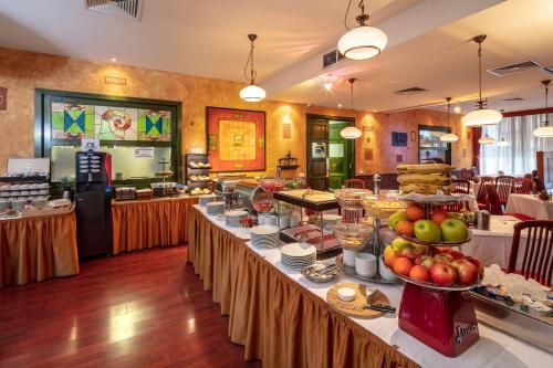 a buffet line with food on display in a restaurant at Hotel Charles in Budapest