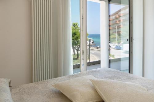 a bedroom with a bed with a view of the ocean at Bellariva Monopoli B&B e Relax in Monopoli