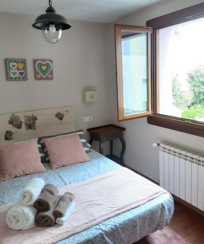 a bedroom with a bed with towels on it at Apartamento Cine Colón 2 in Ribadeo